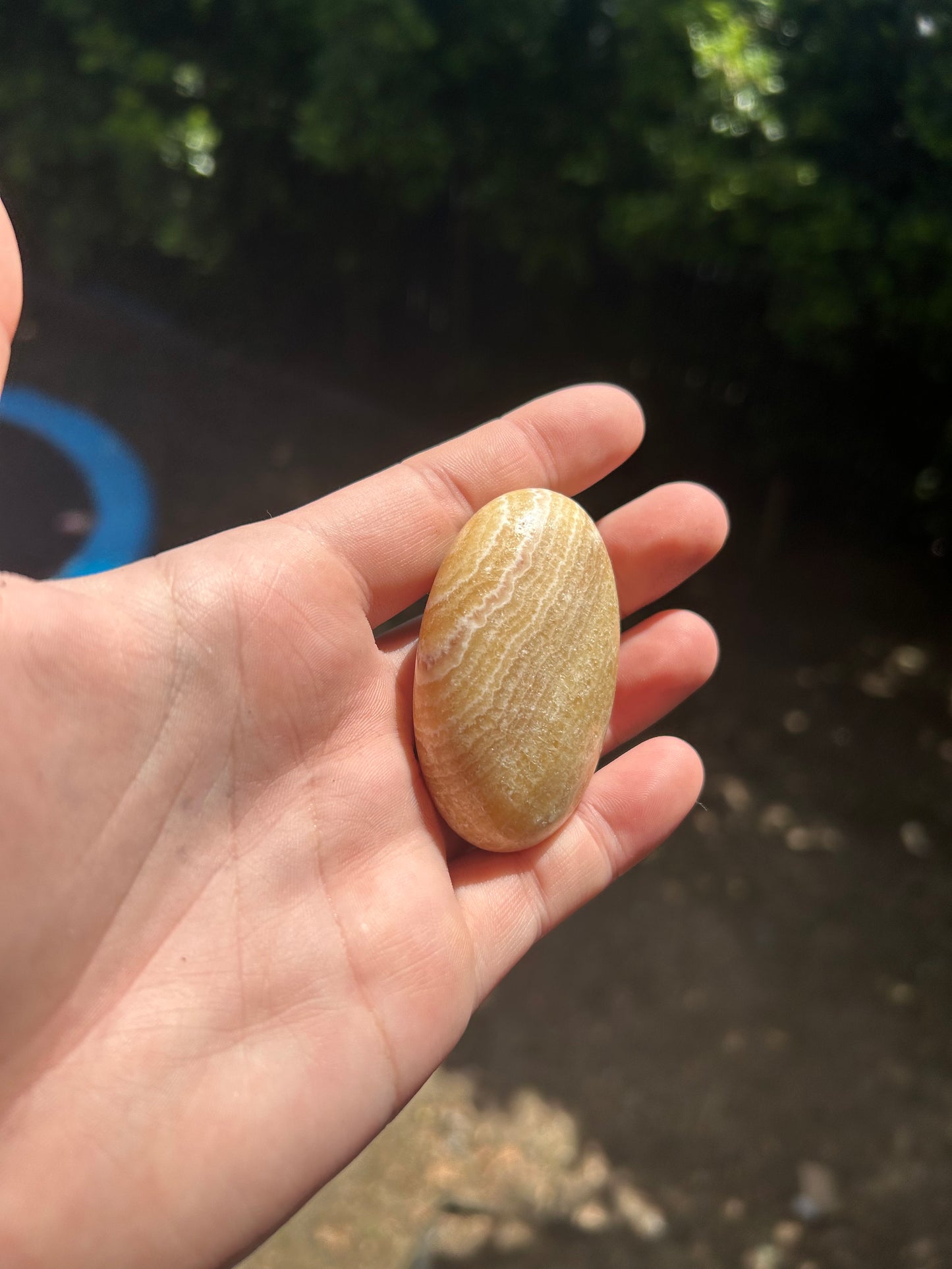 Orange calcite palm stone