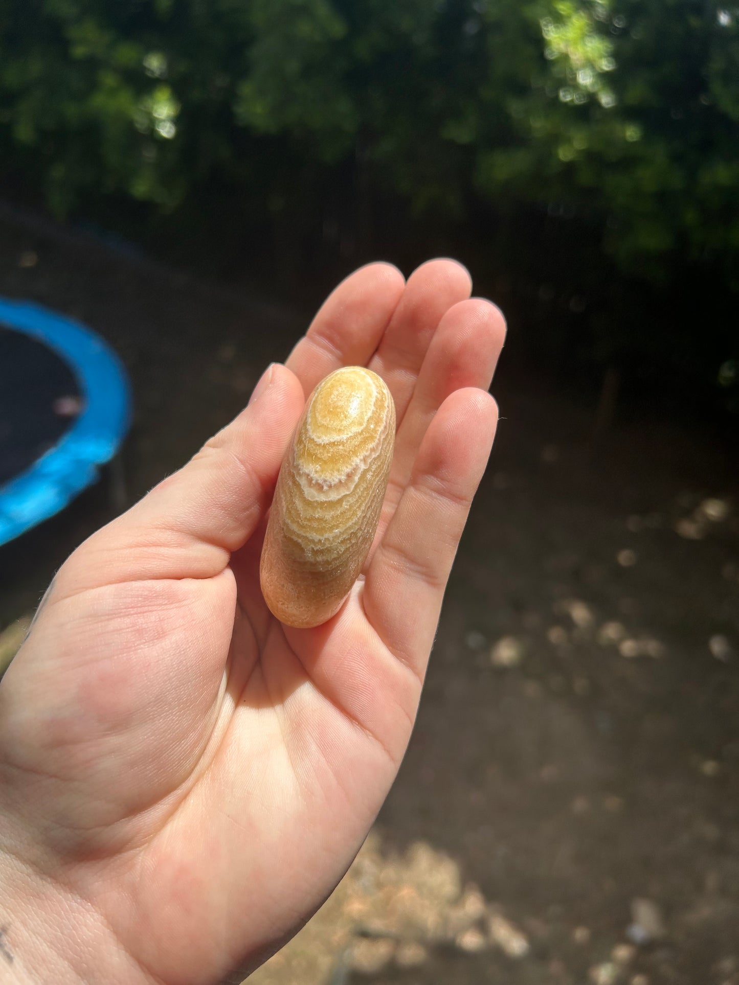 Orange calcite palm stone